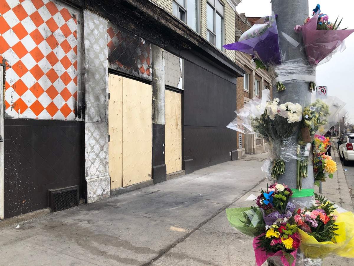 A makeshift memorial of flowers taped to the pole that was the scene of a fatal crash in east Hamilton that killed four people.