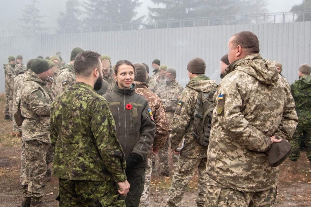 Tetiana Muzychuk, an interpreter for the Canadian Forces mission in Ukraine, at work. Soldiers' faces and insiginia have been blurred.