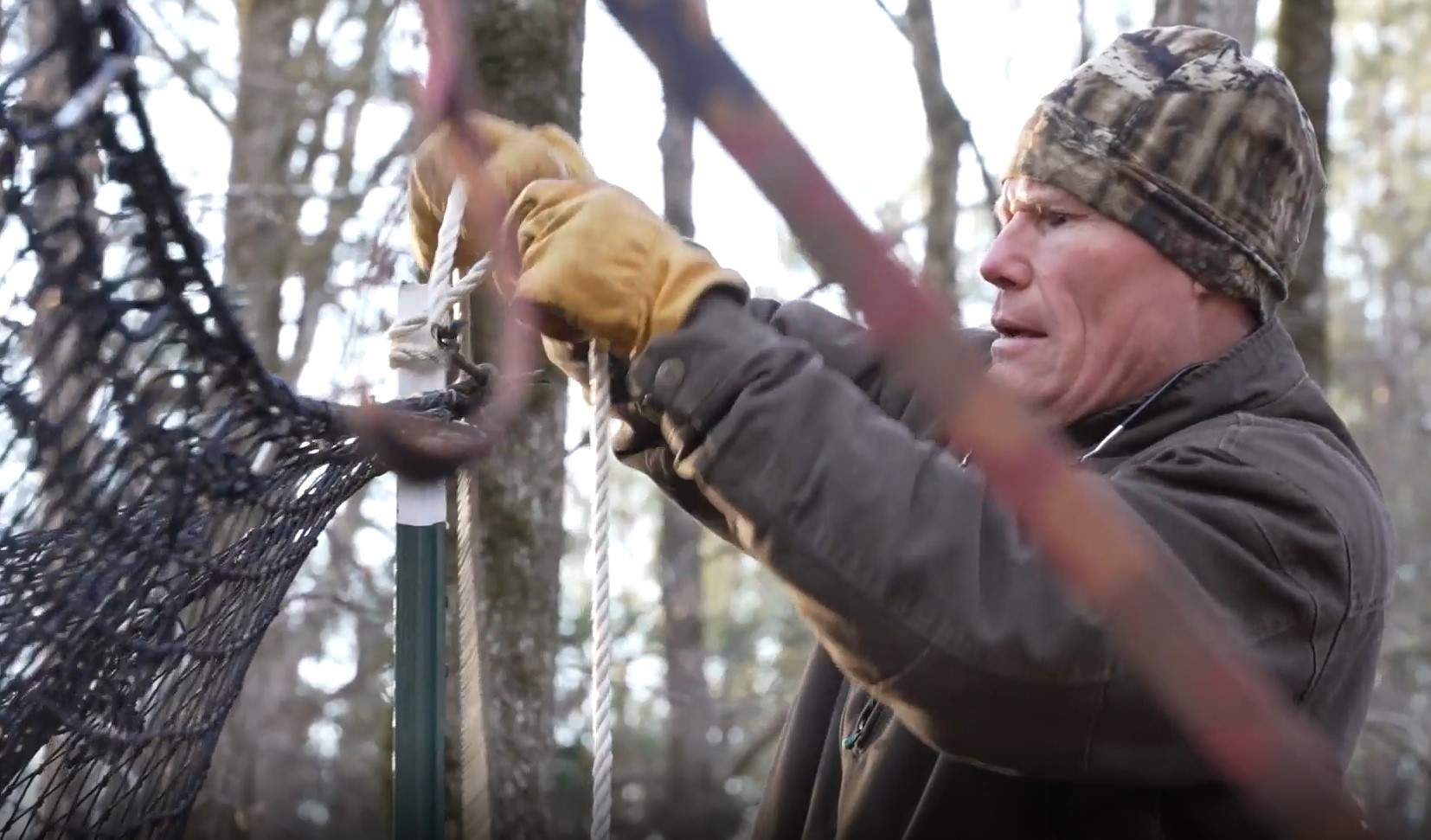 Tony DeNicola is taking down a trap he set to catch feral pigs in South Carolina