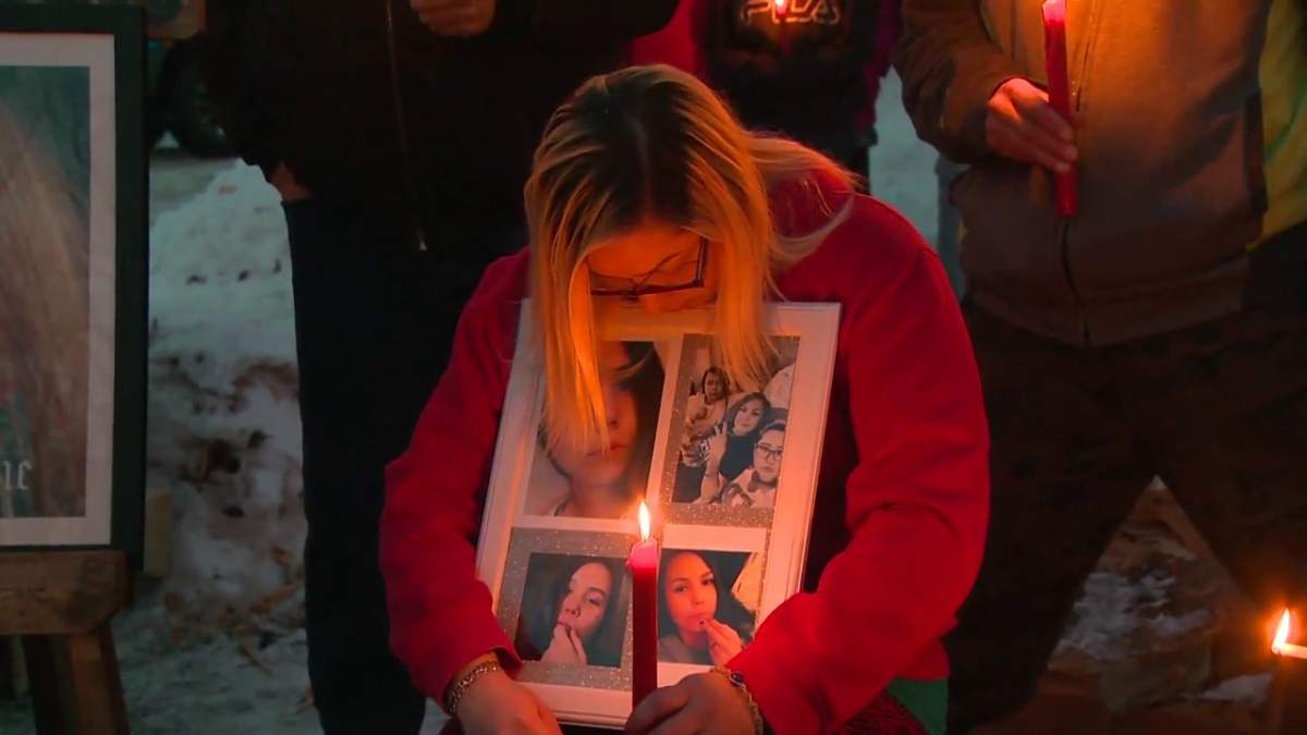 Tori Janvier holds pictures of her sister Tytiana Janvier at a vigil near Lac La Biche Tuesday, March 15, 2022.