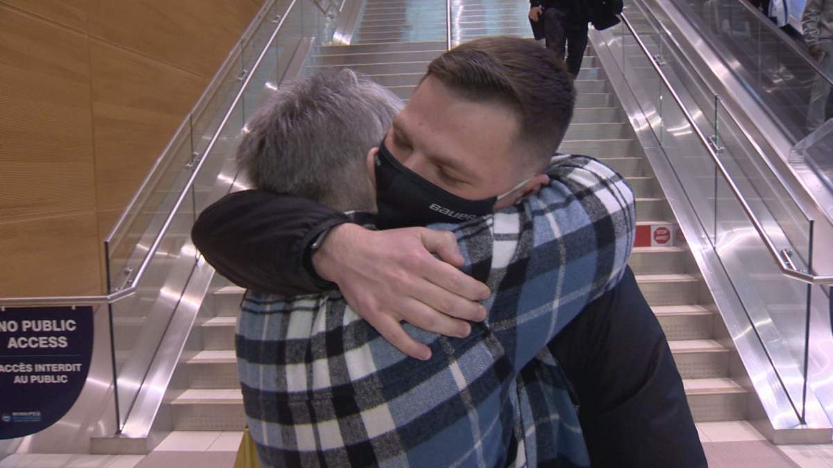 Nikita Sereda and his mom, Yolanta, reunite at the airport in Winnipeg.