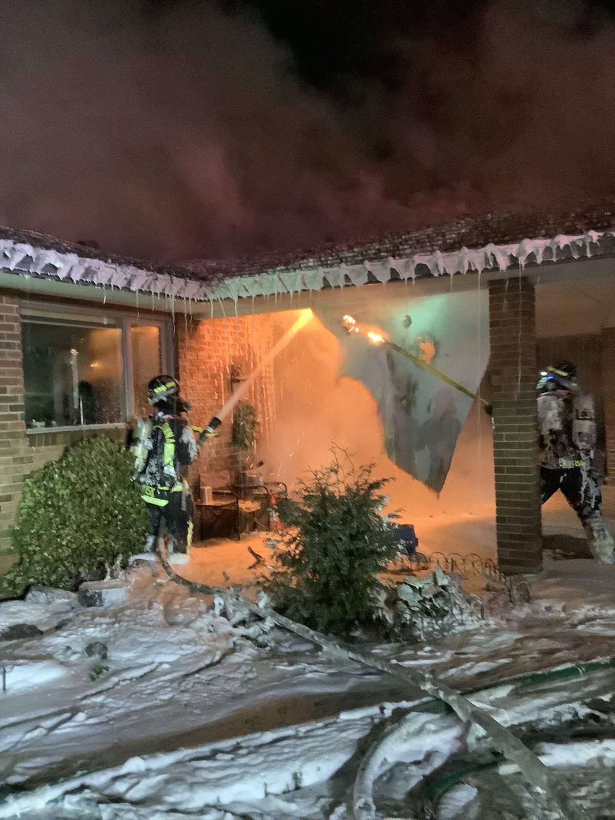 Firefighters battling the house fire along Thacker Drive.