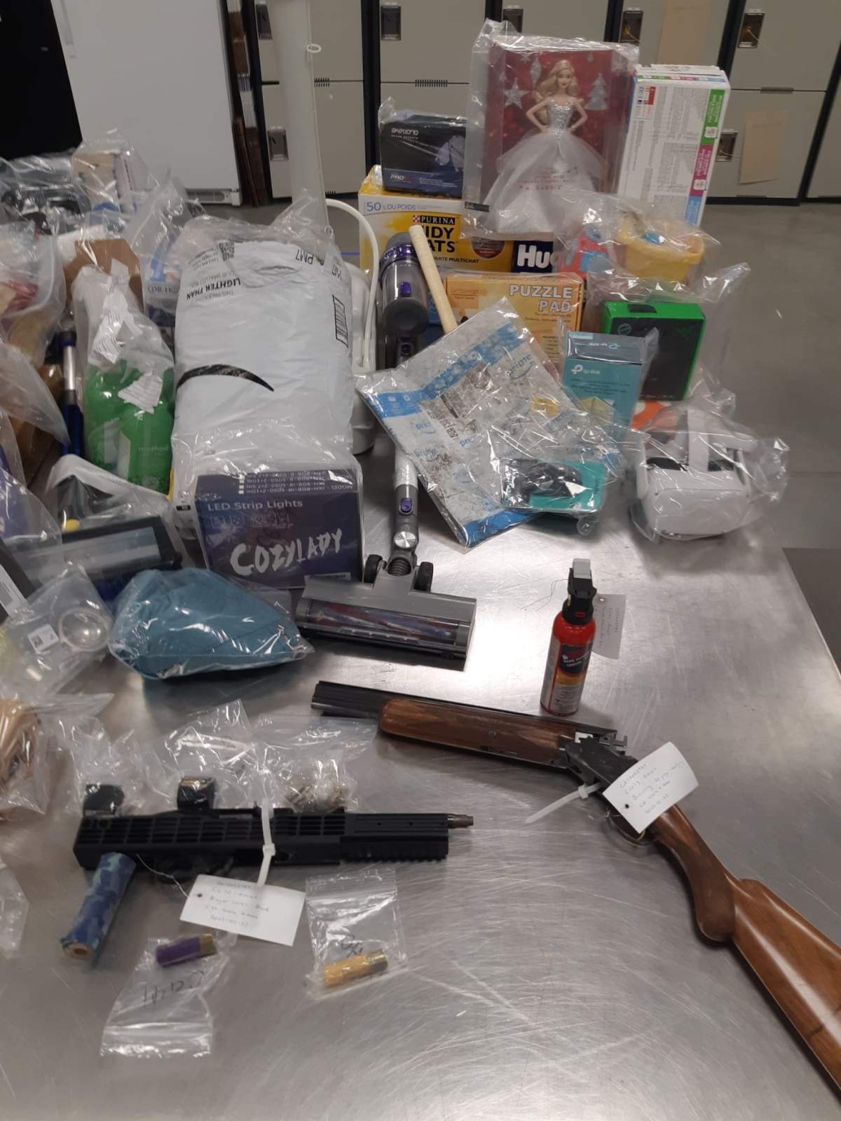 Items seized after four people were charged in connection with the armed carjackings of three Amazon delivery vehicles in Calgary in December 2021 and January 2022.