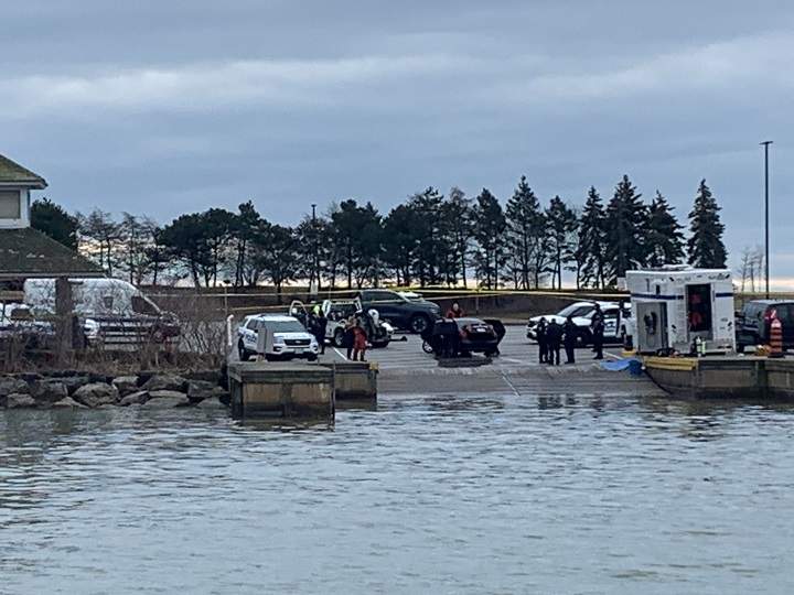 Black car pulled from the water by a tow truck at a Mississauga boat launch on March 24, 2022.