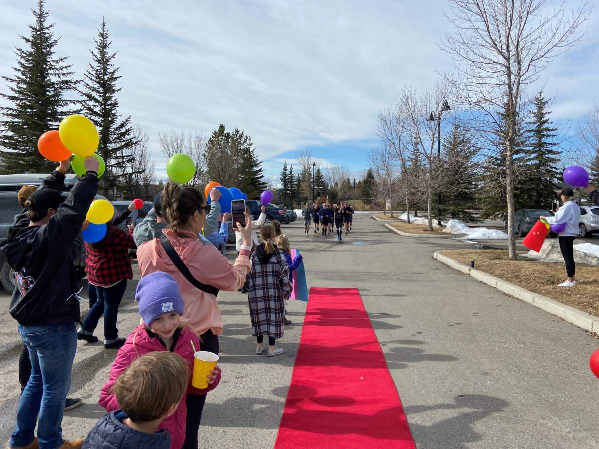 Lorne Miller and friends crossing ‘red carpet’ finish line.