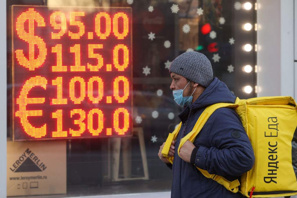 man walking by currency exchange