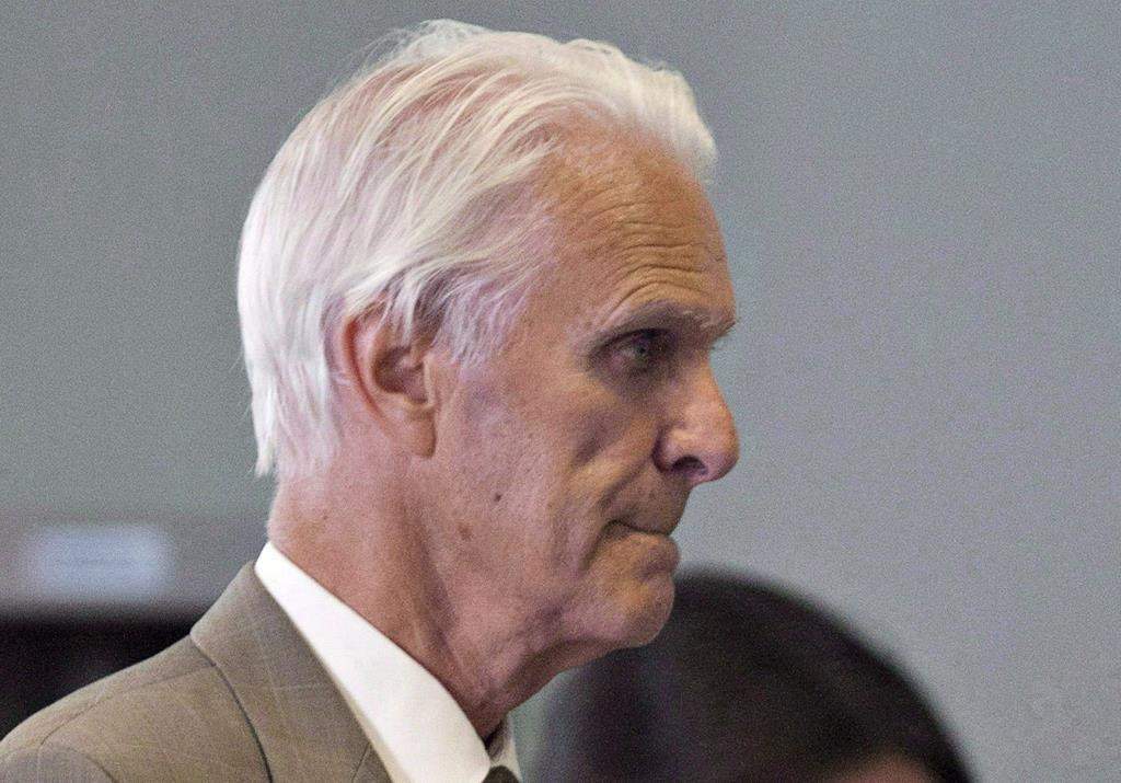 Former Quebec judge Jacques Delisle walks to court in Quebec City on June 14, 2012. A former Quebec judge found guilty in 2012 of fatally shooting his wife only to have that verdict overturned last year by the federal justice minister won't face a new trial. 