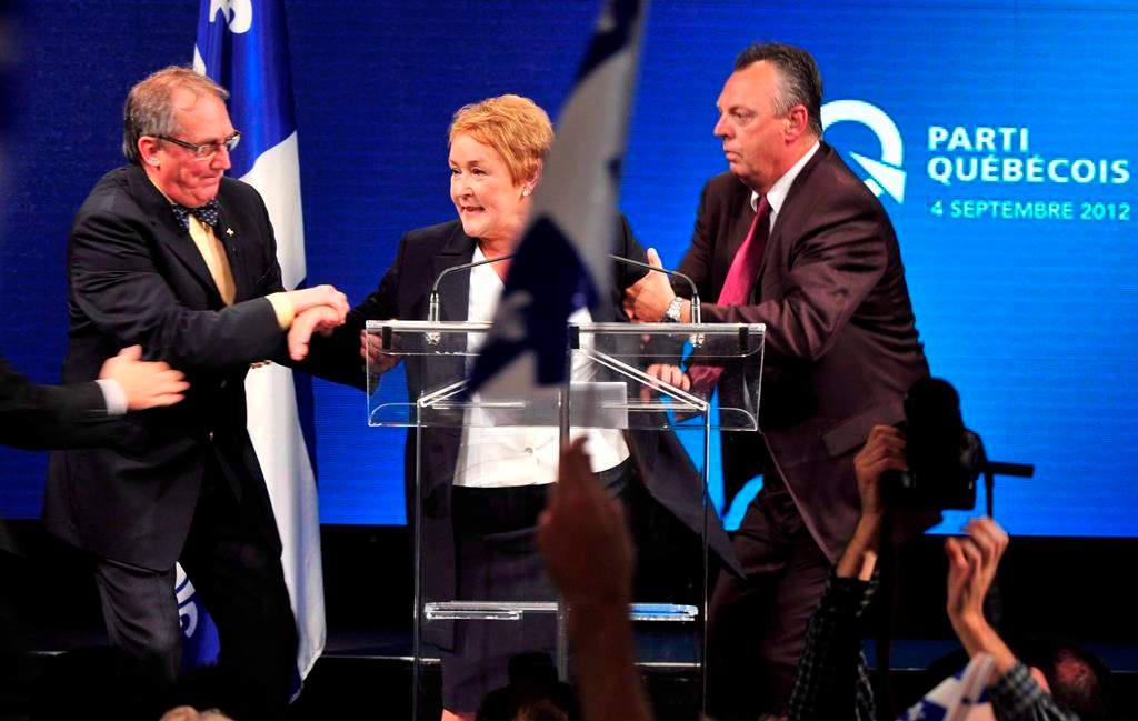 Parti Québécois Leader Pauline Marois is whisked off stage as she delivered her victory speech in Montreal, Tuesday, Sept. 4, 2012. 