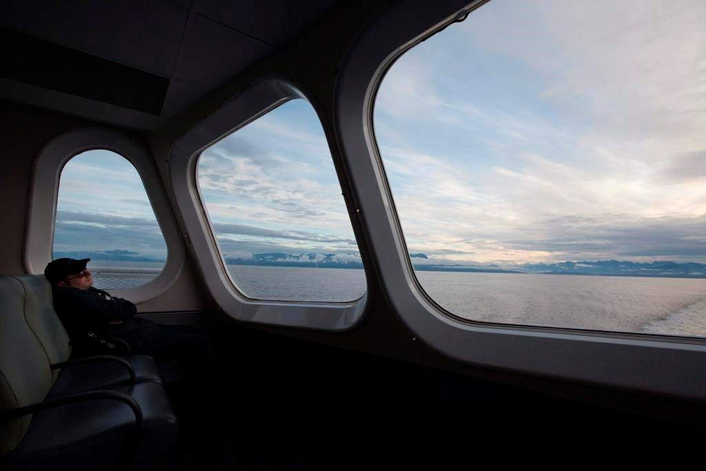 A passenger catches a nap as the morning light rises over the waters of Horseshoe Bay as the ferry Queen of Oak Bay departs for Nanaimo, B.C. early Tuesday, Sept. 7, 2010.