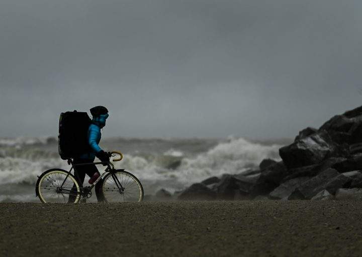 A person watches the waves roll in on Lake Ontario at Woodbine Beach on a windy day in Toronto on Wednesday, December 16, 2020.