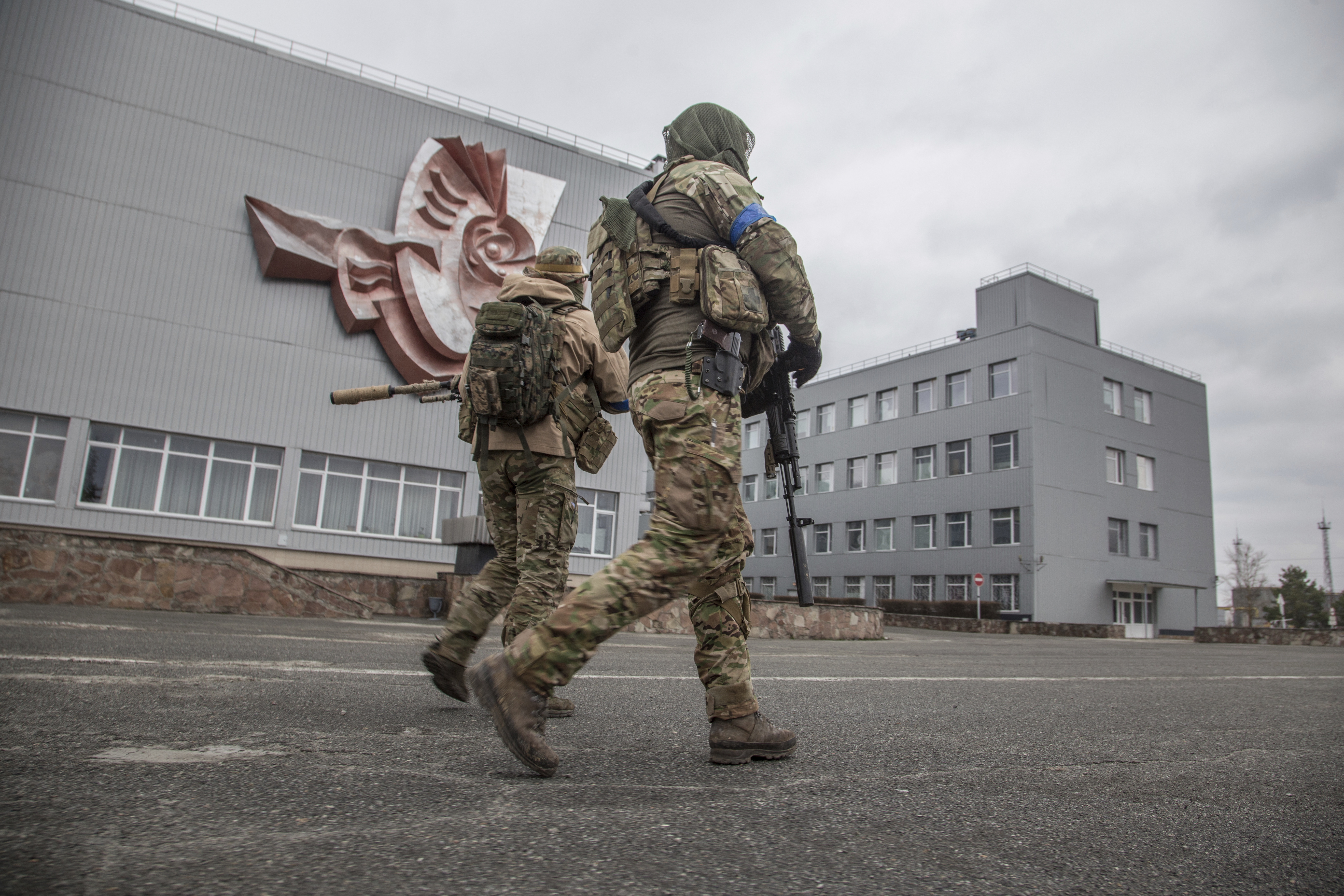Ukrainian servicemen walk at the Chornobyl nuclear plant, Ukraine, Tuesday, April 5, 2022.