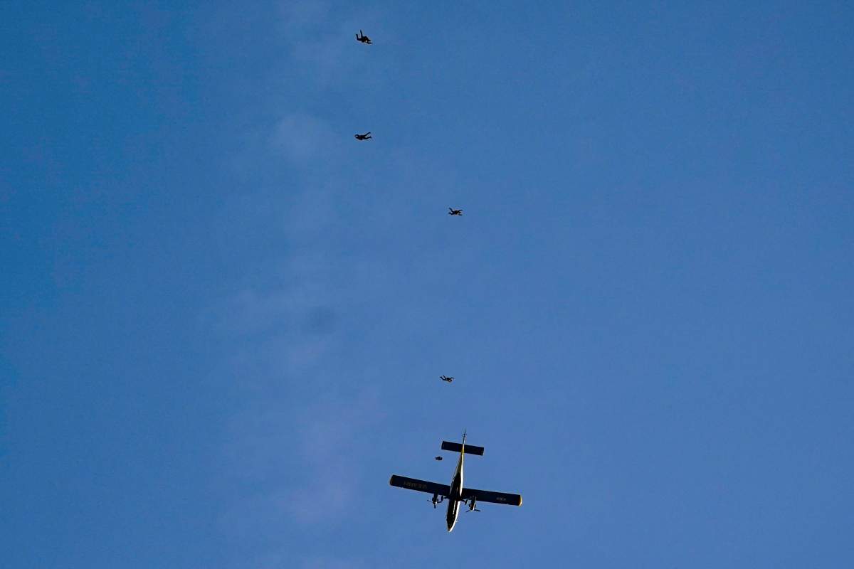 The U.S. Army Parachute Team the Golden Knights jump out of their aircraft before a baseball game between the Washington Nationals and the Arizona Diamondbacks at Nationals Park, Wednesday, April 20, 2022, in Washington. The U.S. Capitol was briefly evacuated after police said they were tracking an aircraft â€œthat poses a probable threat,â€ but the plane turned out to be the military aircraft with people parachuting out of it for a demonstration at the Nationals game, officials told The Associated Press. (AP Photo/Alex Brandon)