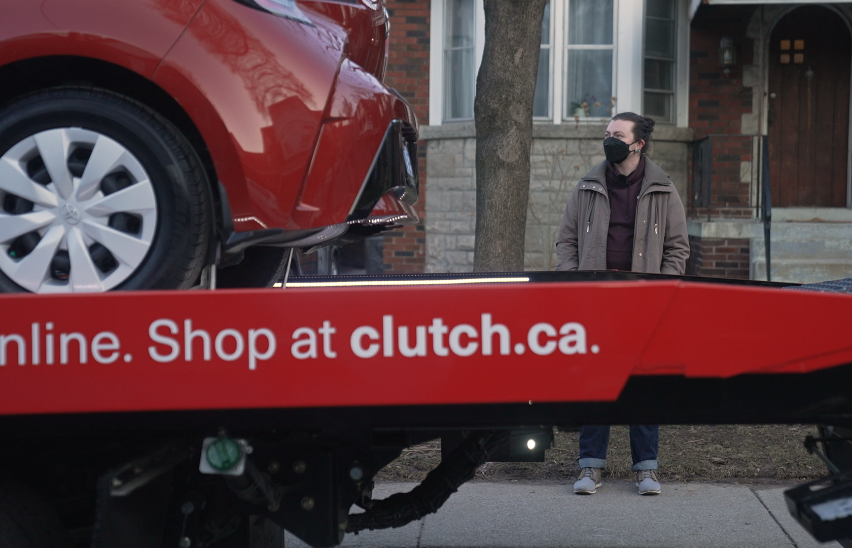 A Clutch delivery truck pulls up in front of customer Haley Reap
