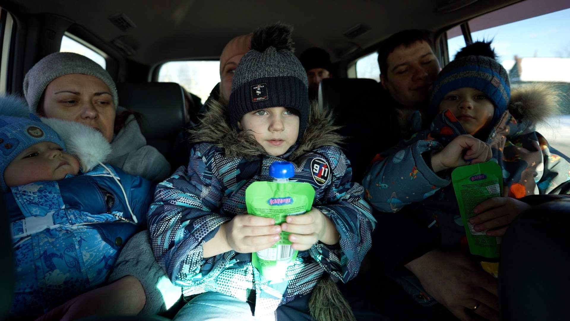Two families pack into the back of Roman Tropin's van headed to Dnipro.