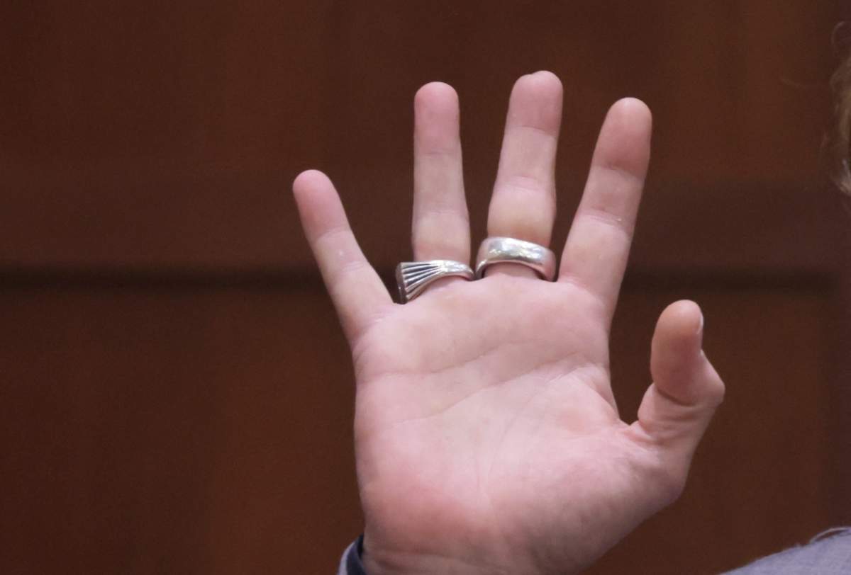 Actor Johnny Depp displays the middle finger of his hand, injured while he and his ex-wife Amber Heard were in Australia in 2015, as he testifies during his defamation trial against Heard at the Fairfax County Circuit Courthouse in Fairfax, Virginia, April 20, 2022.