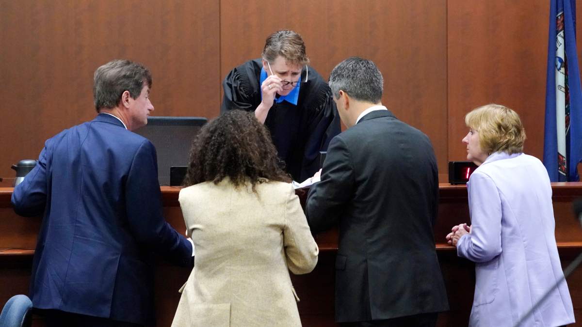 Judge Penney Azcarate talks to attorneys in the courtroom at the Fairfax County Circuit Courthouse in Fairfax, Virginia, April 25, 2022.