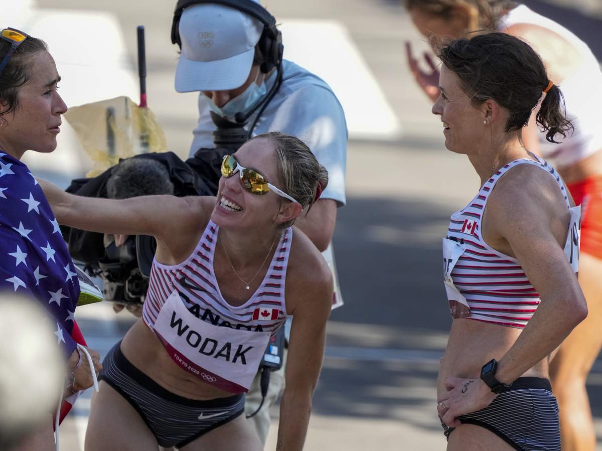 Malindi Elmore of Kelowna, B.C., right — seen here in 2021 in Japan with Canadian runner Natasha Wodak, middle, and Molly Seidel of the U.S. — placed 11th in the women’s race at the Boston Marathon on Monday.