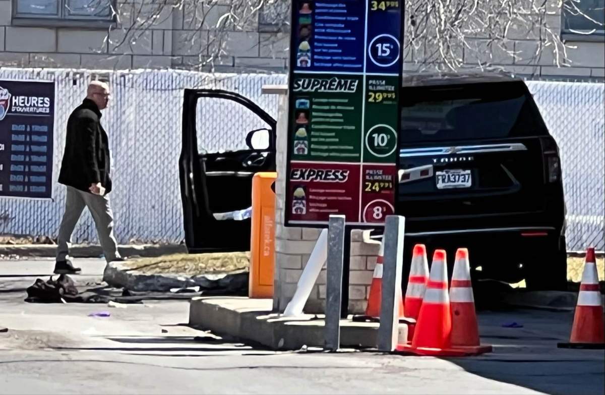 Montreal police examine the vehicle of a man who was shot in the city's east end on April 12, 2022.