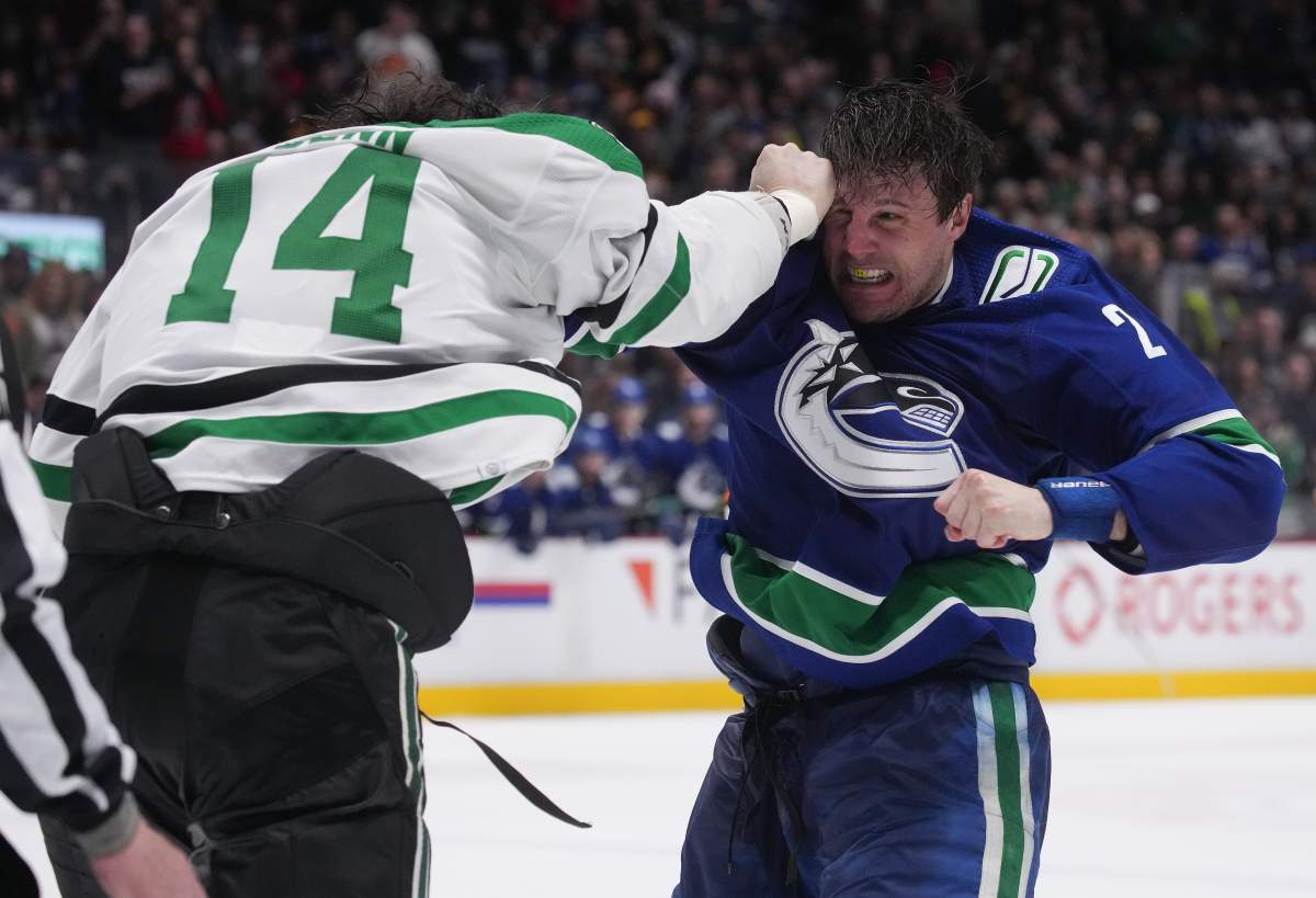 Luke Schenn of the Vancouver Canucks, right, and Jamie Benn of the Dallas Stars fight during the second period of Monday night’s game in Vancouver.