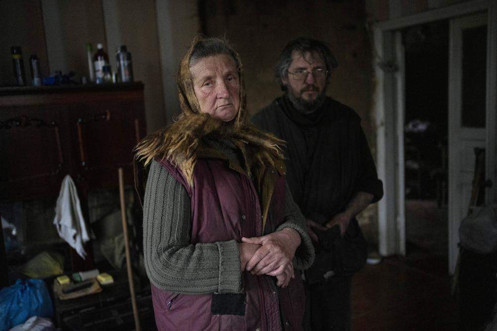 Nadiya Trubchaninova, 70, poses for the picture with her son Oleg Trubchaninov, 46, inside the room of her son Vadym, 48, who was killed by Russian soldiers last March 30 in Bucha, in the outskirts of Kyiv, Ukraine, Wednesday, April 13, 2022.
