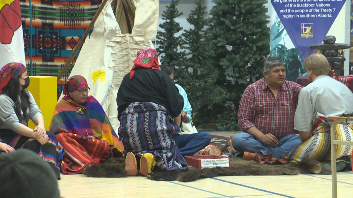 Elders apply face paint to St. Francis Junior High School faculty members, as part of naming ceremony on Apr. 13, 2022.
