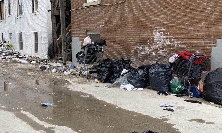 Garbage is seen piled up behind a Winnipeg apartment building.