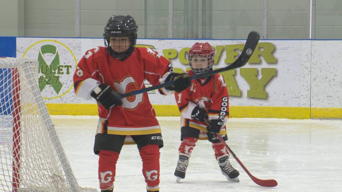 Players chase after the puck. Alberta Treaty Hockey Games on Apr. 14, 2022.