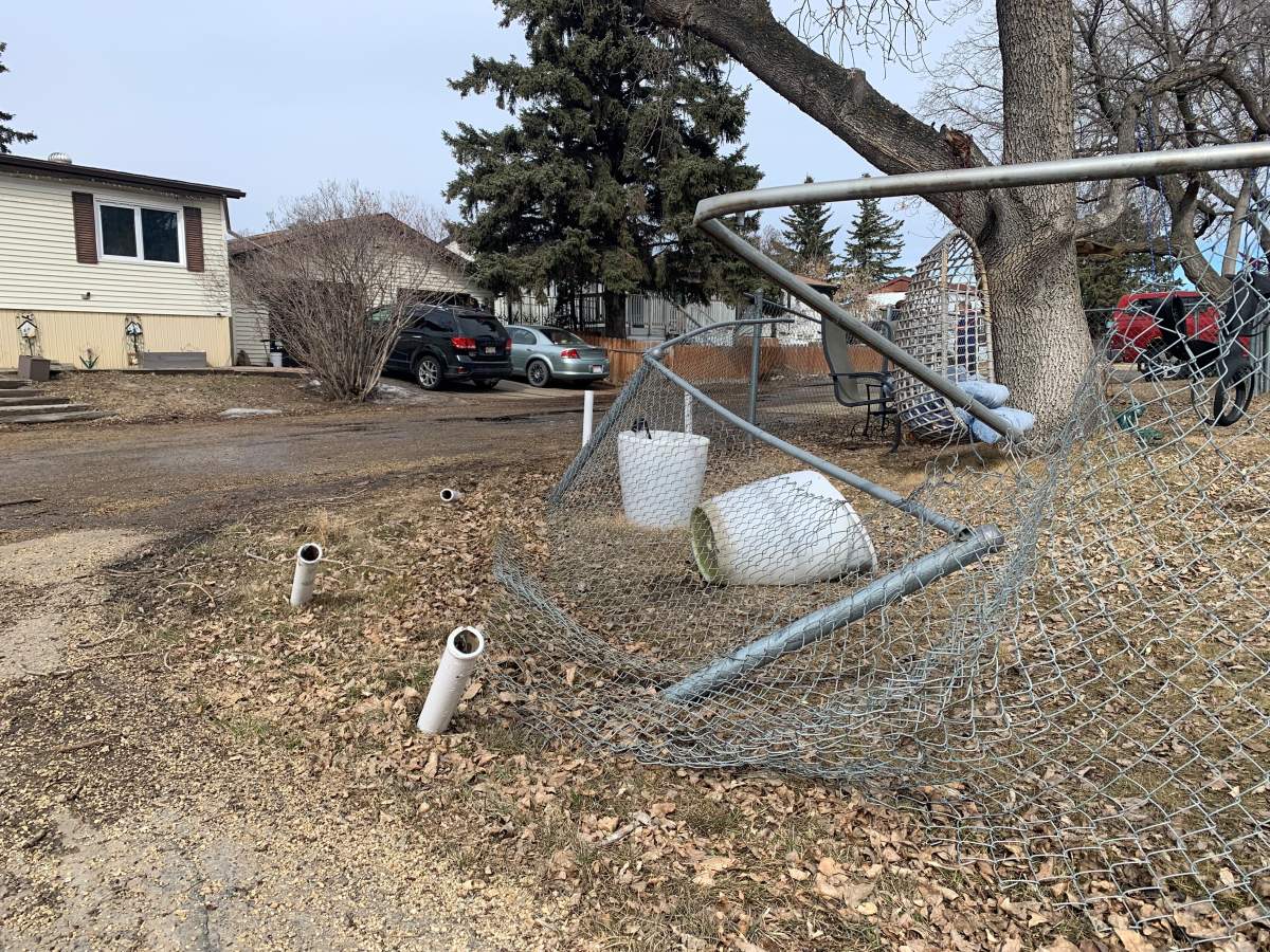 A damaged fence at the Evergreen Trailer Park in Edmonton Monday, April 4, 2022, one day after a police chase that started with a suspicious vehicle at the park.