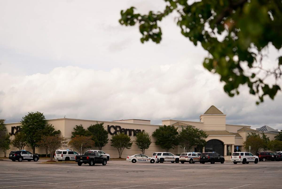 Authorities stage in a parking lot at Columbiana Centre mall in Columbia, S.C., following a shooting, Saturday, April 16, 2022.