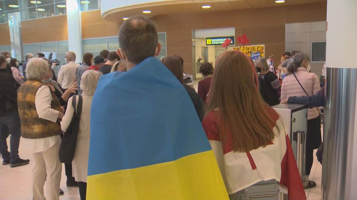 Dozens of people waiting at the Winnipeg International airport for the first of three charter flights en route to Canada from Ukraine.