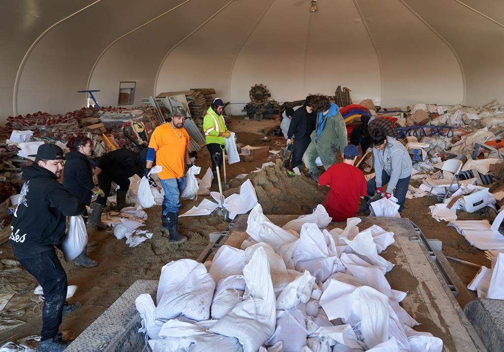 Volunteers prepare sandbags during flooding in Peguis First Nation, Man., Wednesday, May 4, 2022.