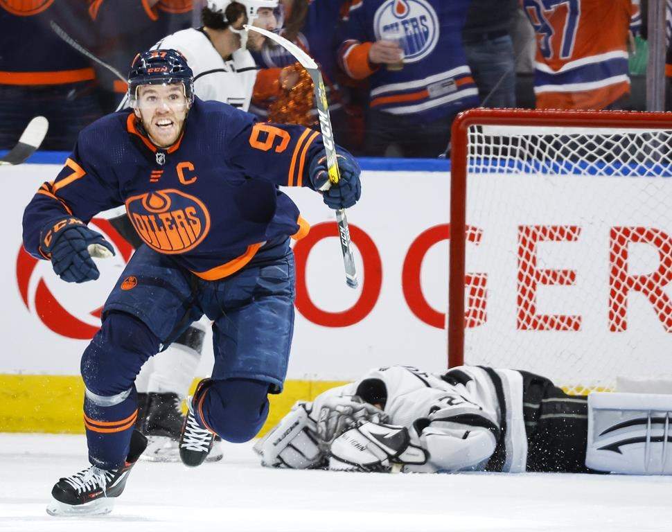 Los Angeles Kings goalie Jonathan Quick, right, lies on the ice as Edmonton Oilers centre Connor McDavid celebrates his goal during third period NHL playoff hockey action in Edmonton, Saturday, May 14, 2022.