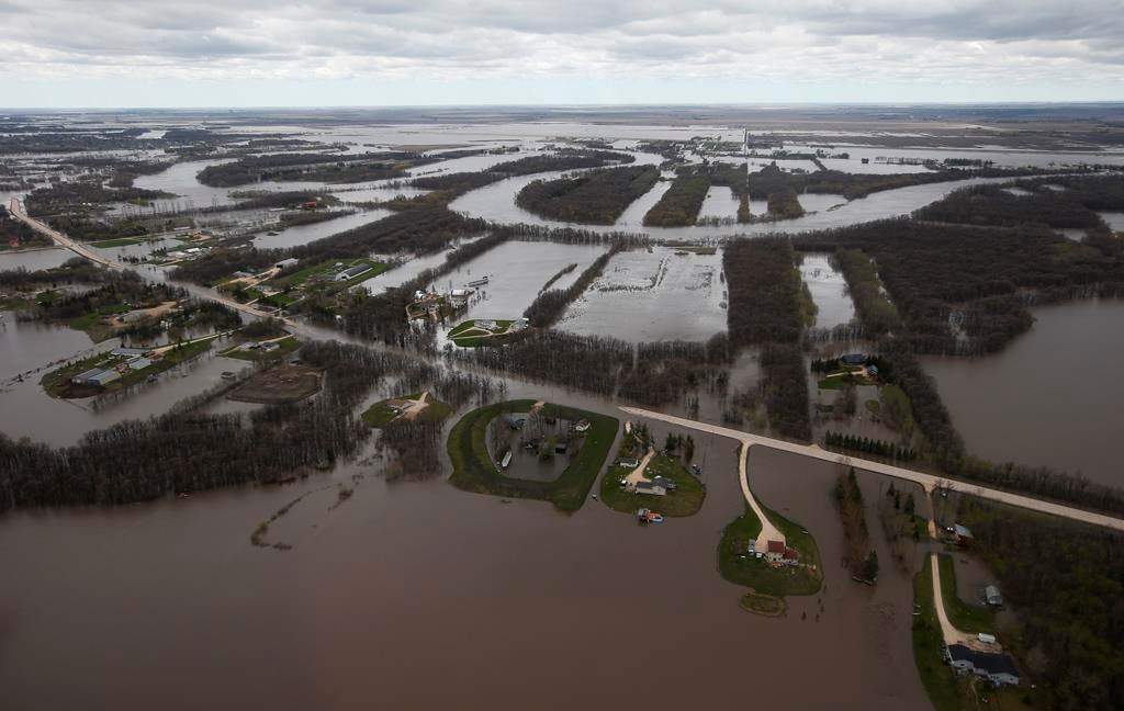 St Mary’s Road, which runs between Winnipeg and St Adolphe, Man., is closed due to Red River flooding south of Winnipeg, Sunday, May 15, 2022.