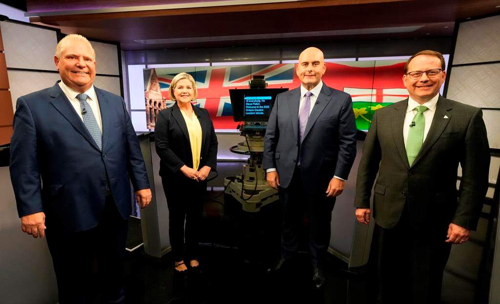 Ontario Progressive Conservative Party Leader Doug Ford, left to right, Ontario New Democratic Party Leader Andrea Horwath, Ontario Liberal Party Leader Steven Del Duca and Green Party of Ontario Leader Mike Schreiner pose for a photo ahead of the Ontario party leaders' debate, in Toronto, Monday, May 16, 2022. Ontario's election campaign will run half virtually, half in-person today, as the leaders for the New Democratic and Green parties isolate with COVID-19. THE CANADIAN PRESS/Frank Gunn.