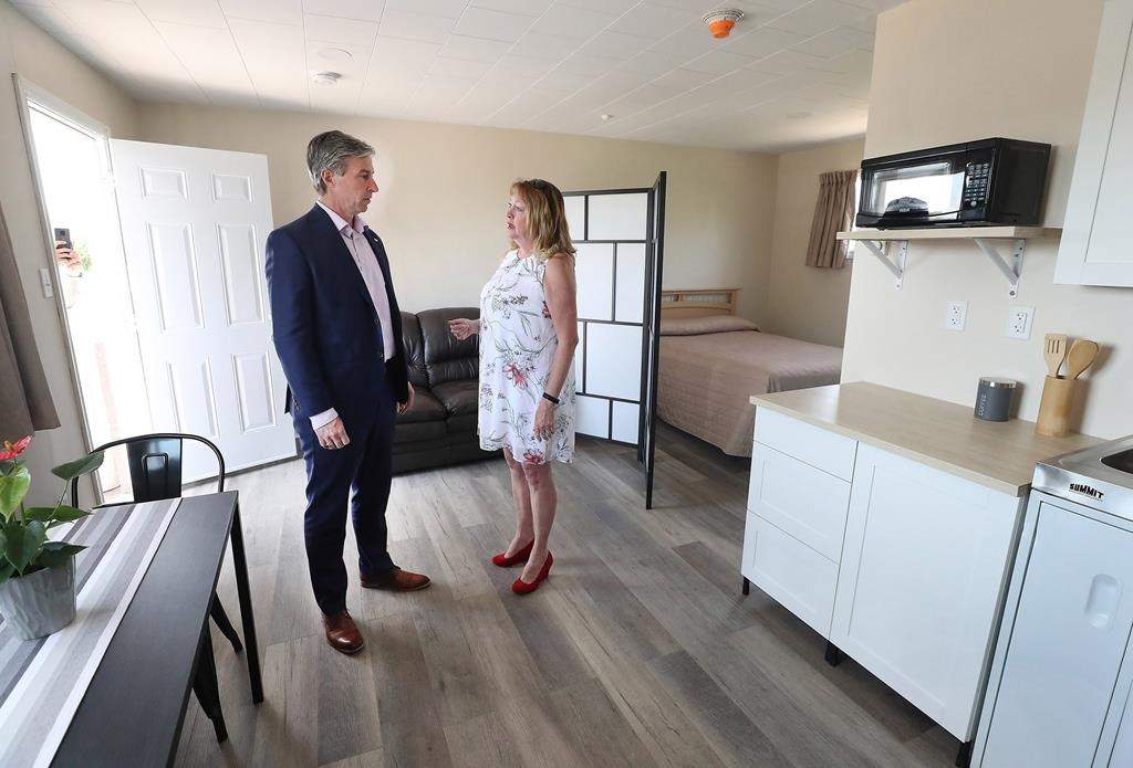 Nova Scotia Premier Tim Houston is seen with Nova Scotia Co-operative Council President and CEO Dianne Kelderman during a tour of a model unit in New Glasgow, N.S., in a Thursday, May 26, 2022, handout photo. The Nova Scotia and federal governments are providing $5 million for a housing project in New Glasgow, N.S., that converted a motel into 36 affordable housing units.