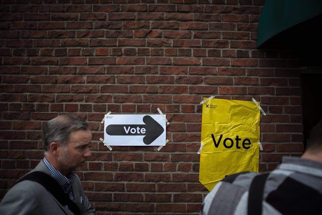 Voters line up to cast a ballot in the Ontario provincial elections in Toronto on Thursday, June 7, 2018. 