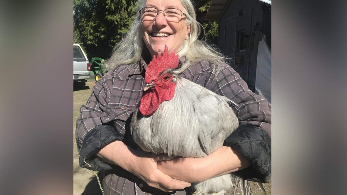 Peggy Ife poses with George, one of her prized birds, in happier times. George was one of dozens of Ife’s birds that died because of avian flu in April.