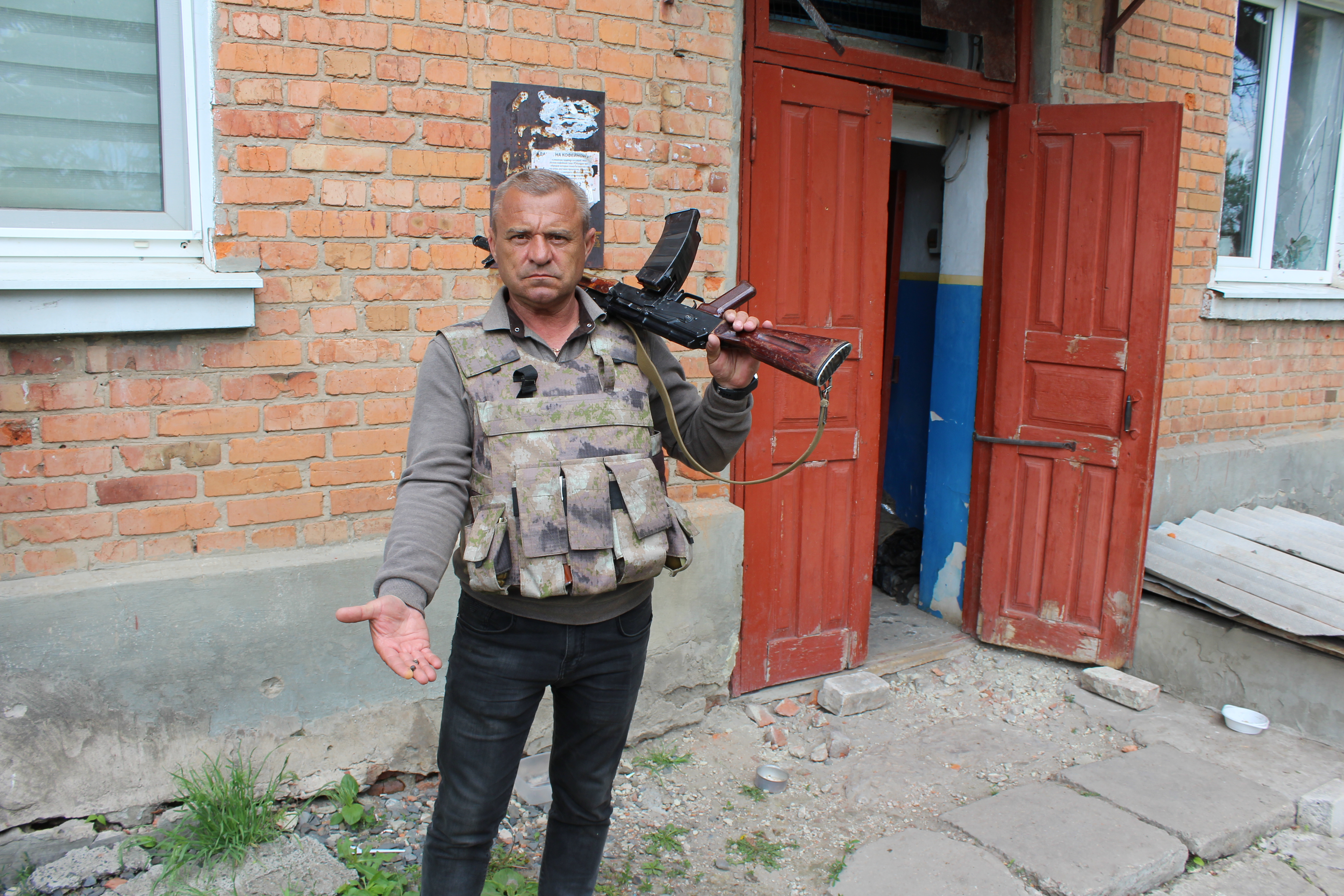 Mayor Oleksandr Balo, with fragments from cluster munitions fired by Russian forces at of Barvinkove in eastern Ukraine, May 19, 2022.