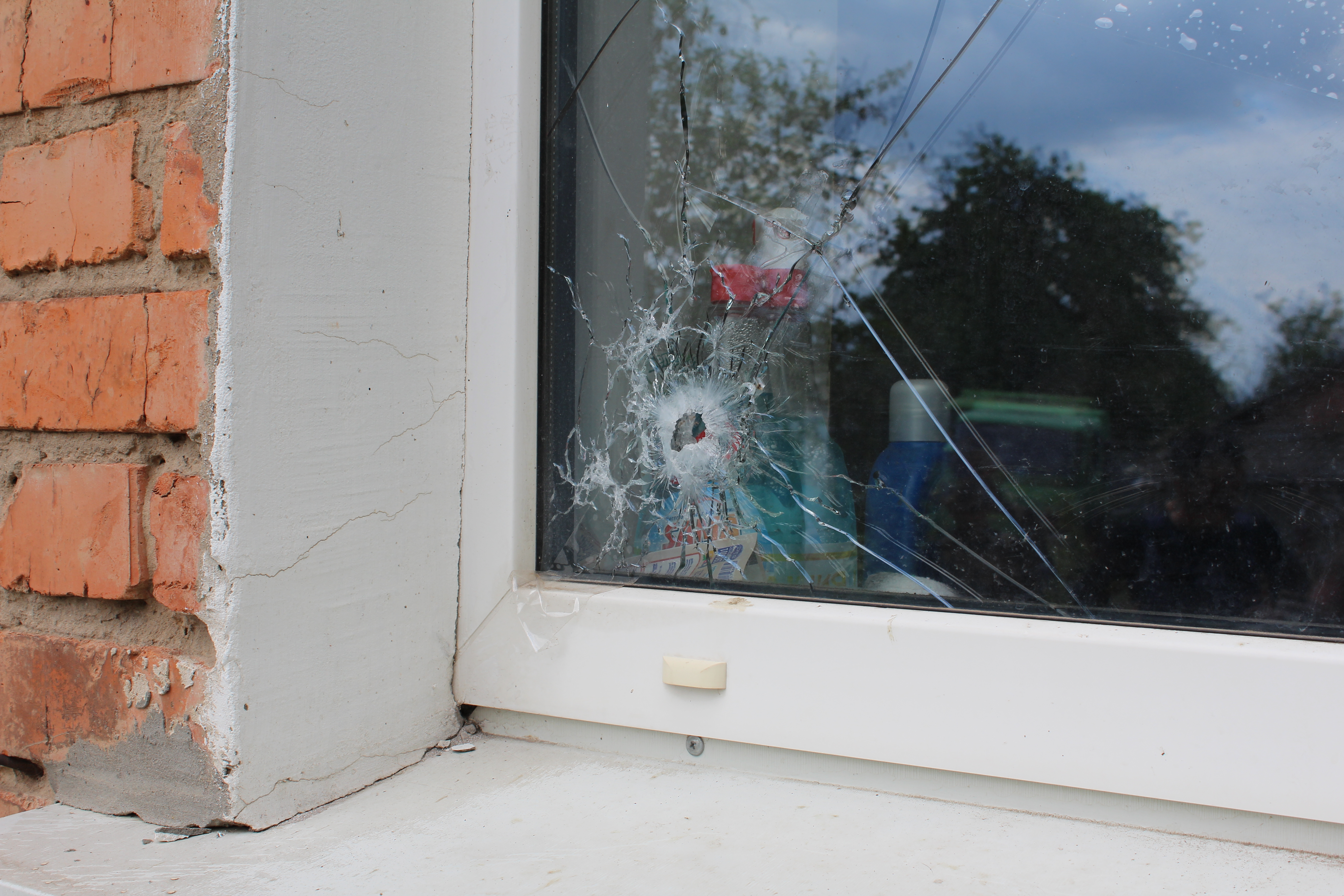 Window of residence that appears to have been hit by shrapnel from cluster munition in Berinkove, Ukraine, May 19, 2022.