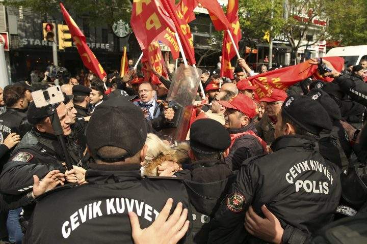 Demonstrators clash with Turkish police officers during a May Day protest in Istanbul, Turkey, Sunday, May 1, 2022.