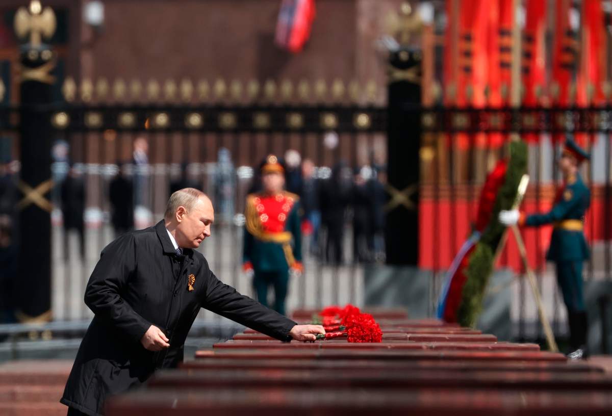 Russian President Vladimir Putin attends a wreath-laying ceremony at the Tomb of the Unknown Soldier after the military parade marking the 77th anniversary of the end of World War II in Moscow, Russia, Monday, May 9, 2022.
