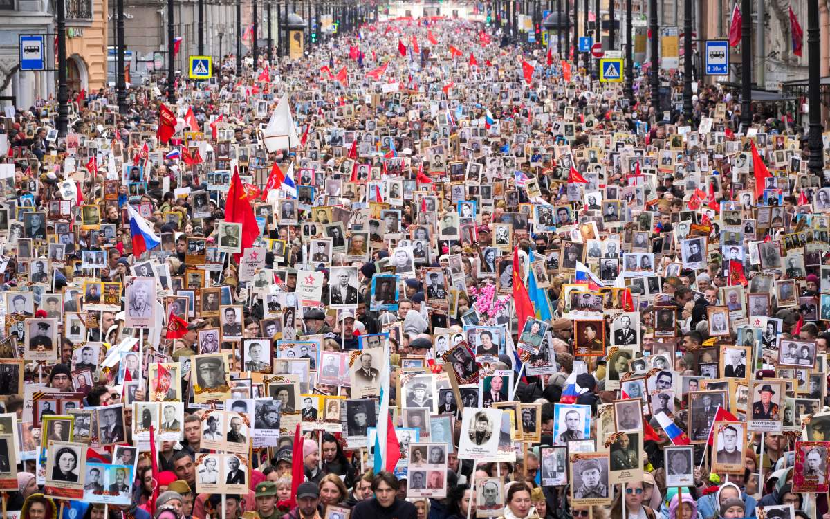 People carry portraits of relatives who fought in World War II, during the Immortal Regiment march in St. Petersburg, Russia, Monday, May 9, 2022, marking the 77th anniversary of the end of World War II.