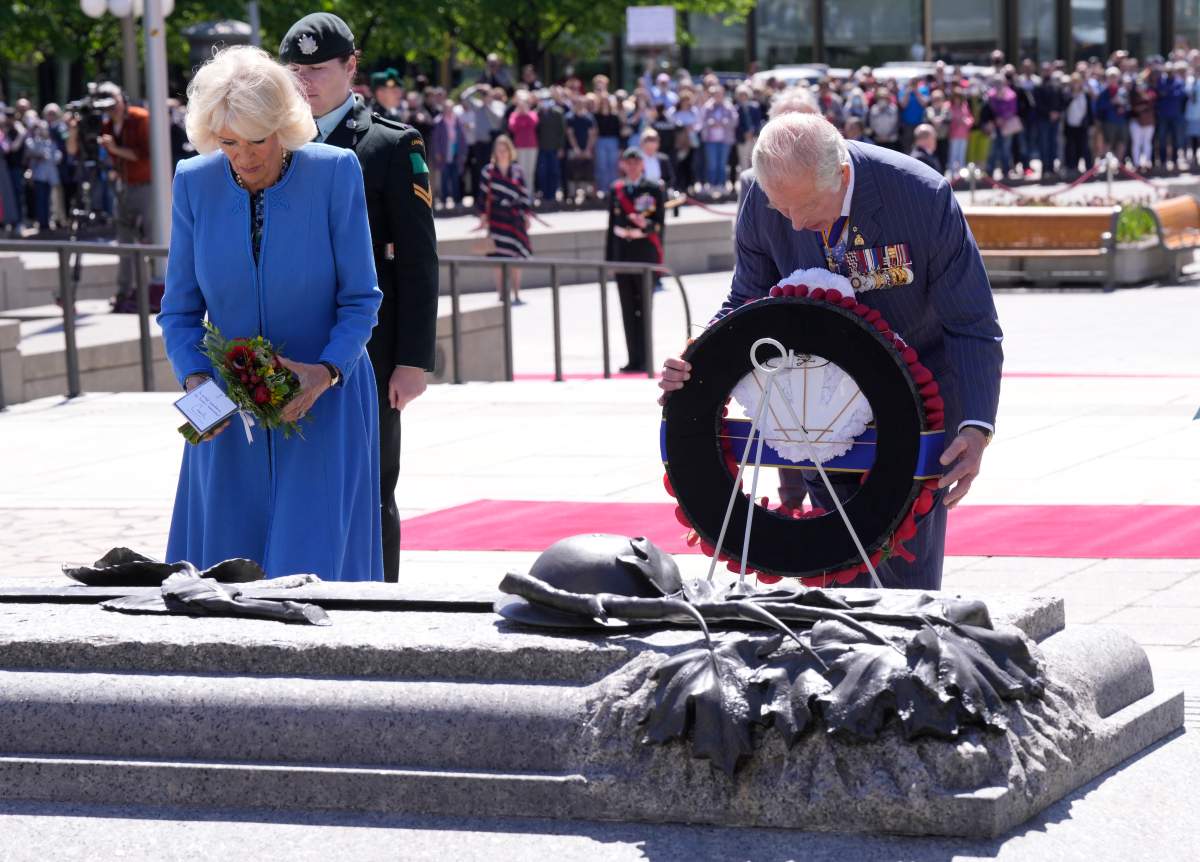 Prince Charles places a wreath as he and Camilla, Duchess of Cornwall, visit the National War Memorial in Ottawa, while on their Canadian Royal Tour, Wednesday May 18, 2022.