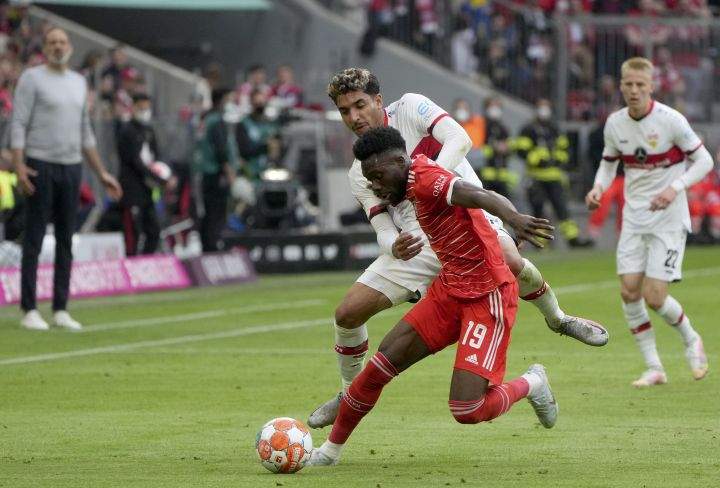 Bayern’s Alphonso Davies, front, duels for the ball with Stuttgart’s Omar Marmoush during the German Bundesliga soccer match between Bayern Munich and Stuttgart, at the Allianz Arena, in Munich, Germany, Sunday, May 8, 2022.