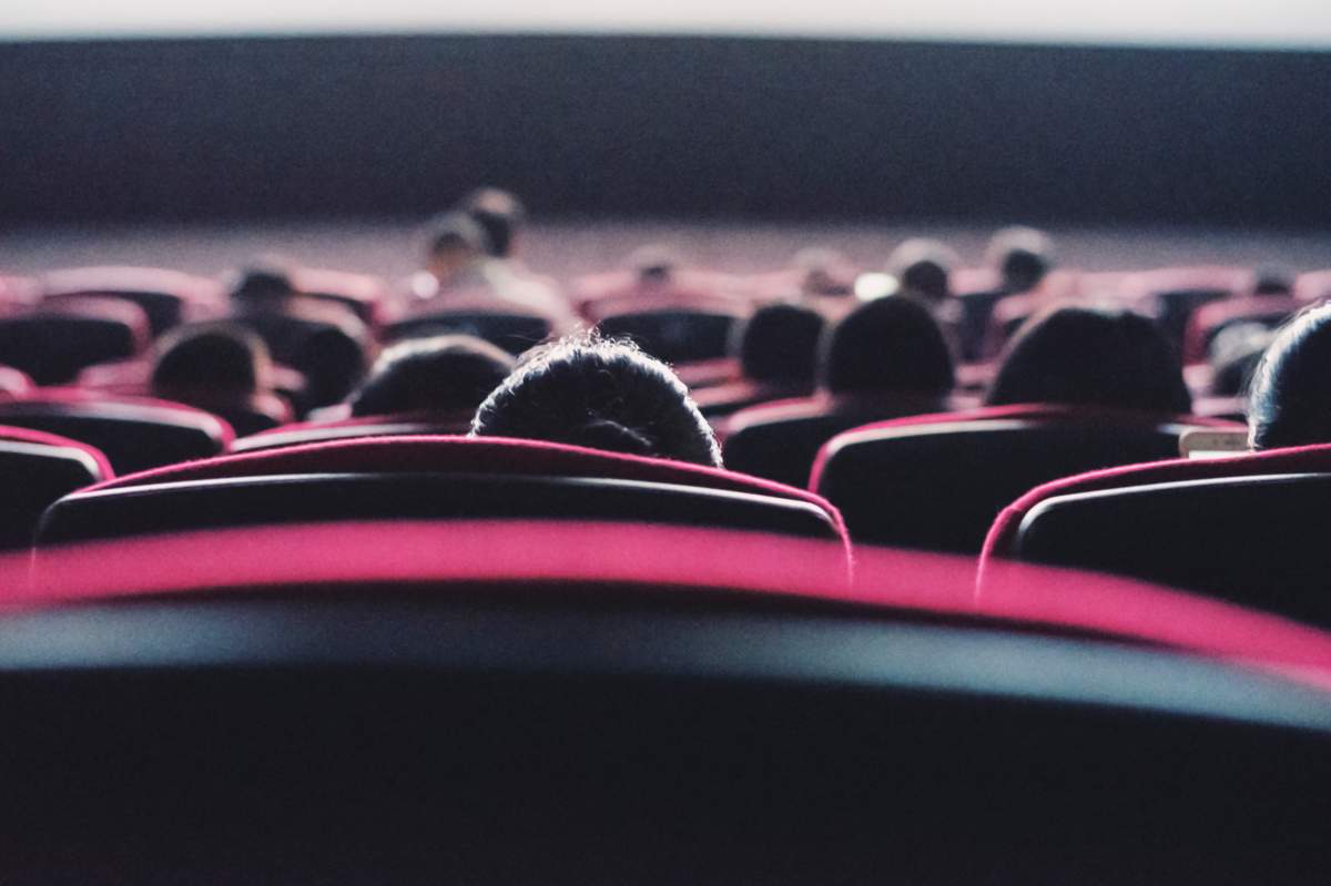 A file photo of the rear view of people at a theatre.