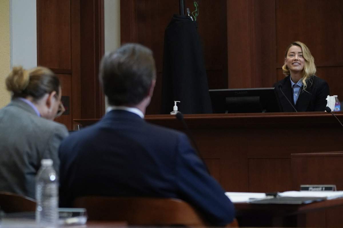 Actor Amber Heard reacts as she testifies at Fairfax County Circuit Court during a defamation case against her by ex-husband, actor Johnny Depp, in Fairfax, Virginia, on May 4, 2022.