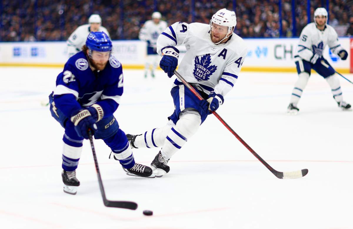 Brayden Point #21 of the Tampa Bay Lightning and Morgan Rielly #44 of the Toronto Maple Leafs fight for the puck in the second period during Game Four of the First Round of the 2022 Stanley Cup Playoffs at Amalie Arena on May 08, 2022 in Tampa, Florida. (Photo by Mike Ehrmann/Getty Images)