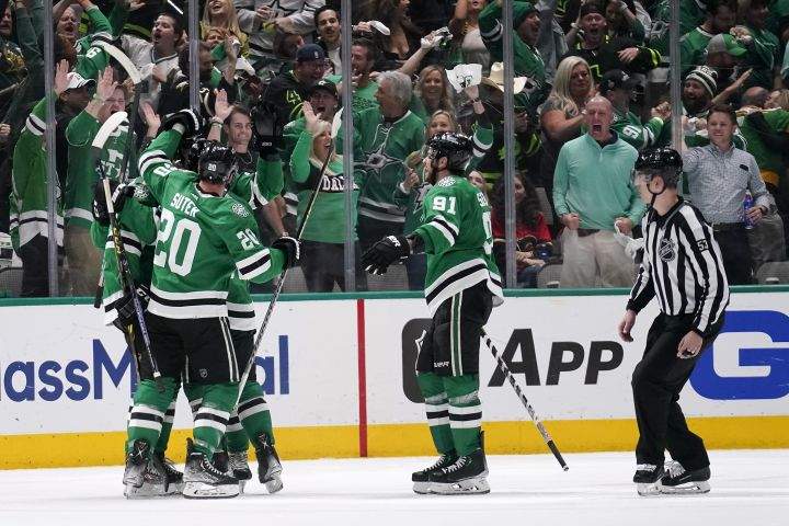 Dallas Stars players celebrate a goal by Miro Heiskanen during the second period of Game 6 of an NHL hockey Stanley Cup first-round playoff series against the Calgary Flames, Friday, May 13, 2022, in Dallas.