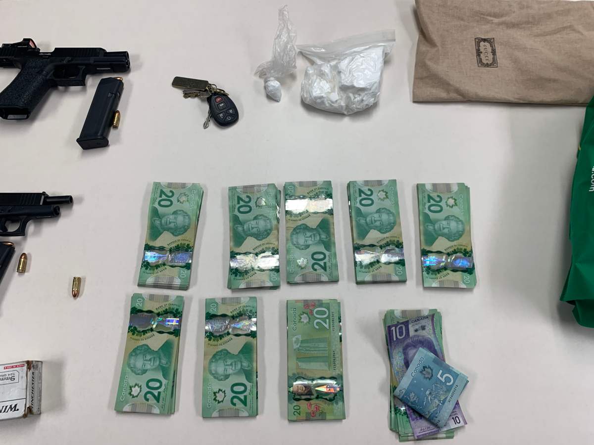 An undated photo of firearms, drugs and cash seized by Strathmore RCMP from a man police believe was involved in a gun store break and enter near Medicine Hat.