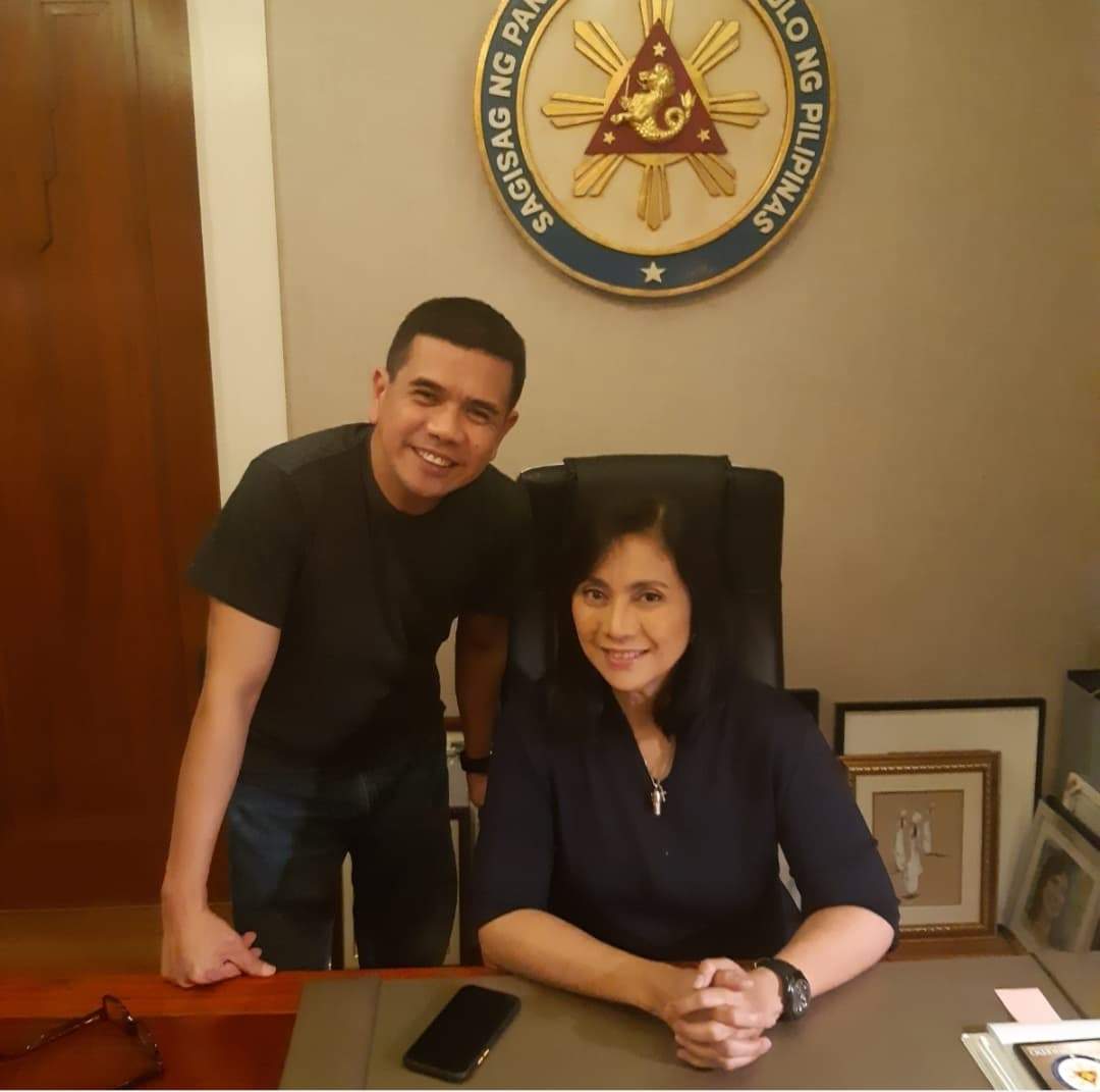 Calgarian Antonio Gerona (L) stands next to his sister former Philippine vice president Leni Robredo, in an undated photo.